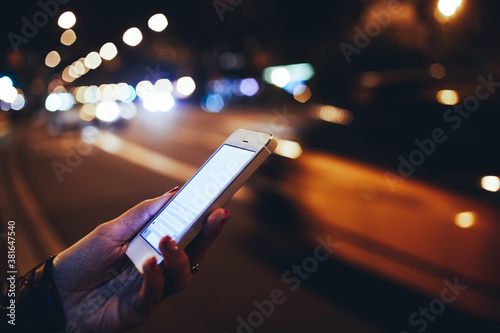 Photography Unrecognizable woman surfing cellphone at night