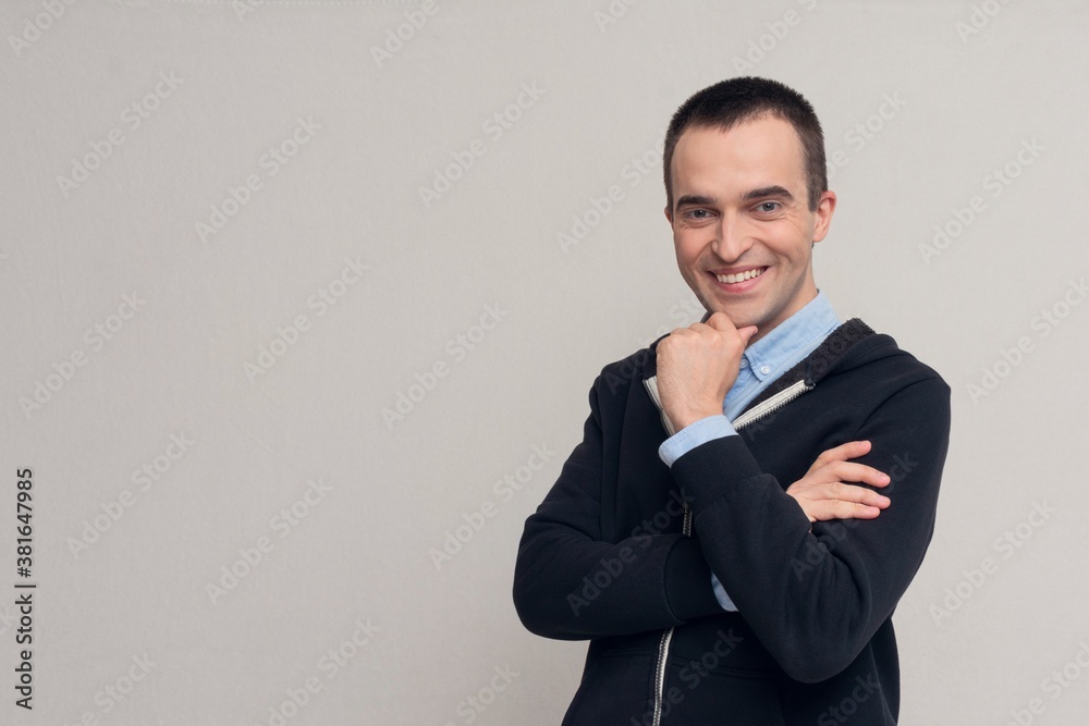 Charming man smiling and looking at the camera, white background, copy space Charming man smiling and looking at the camera, white background, copy space