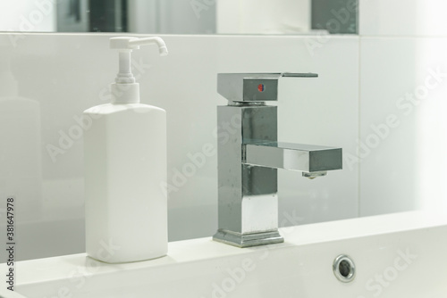 Modern bathroom with sink and soap disinfection fluid  mock-up . Cleaning hands in washbasin.