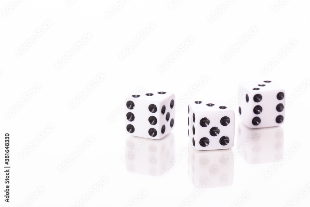 three white dice black pips showing three reflected in glass table surface isolated on white background copy space three white dice black pips showing three reflected in glass table surface isolated on white background copy space