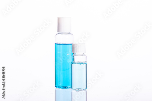 Two transparent containers bottles with liquids isolated on white background. Skin care products, remove makeup, daily deep cleansing, wash toner lotion, moisture mist, micellar cleanser for dry skin