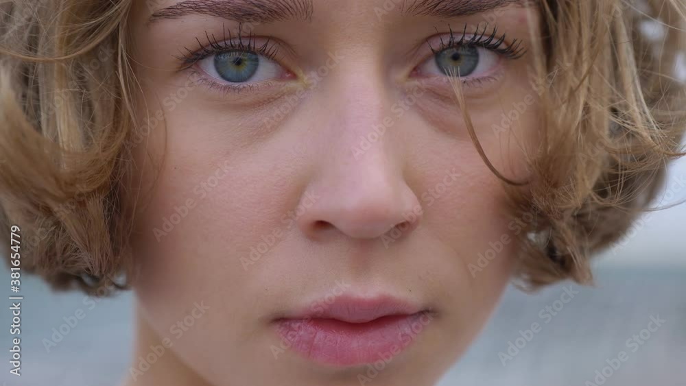 close up portrait of a beautiful blonde young caucasian woman outdoors, wind blowing hair, sad, depressed, emotional portrait close up portrait of a beautiful blonde young caucasian woman outdoors, wind blowing hair, sad, depressed, emotional portrait