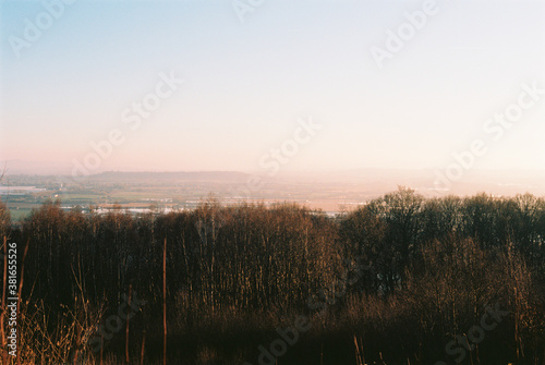 A faded pastel sunset sky over the countryside