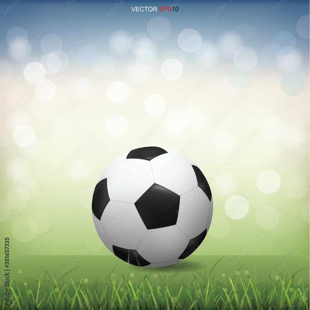 Obraz premium Soccer football ball on green grass field with light blurred bokeh background. Vector.