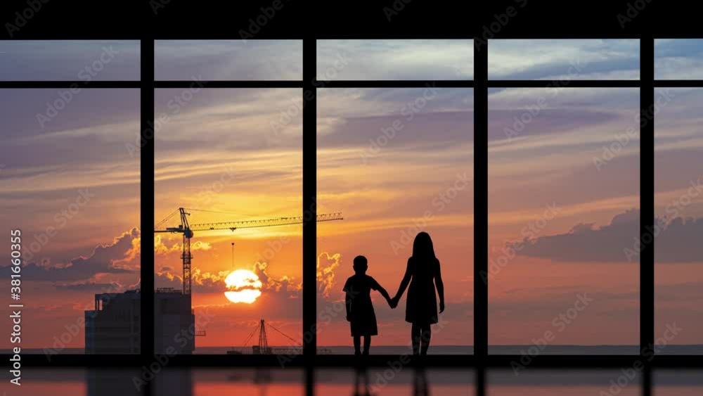 The two kids stand near the big windows on the building background. time lapse The two kids stand near the big windows on the building background. time lapse