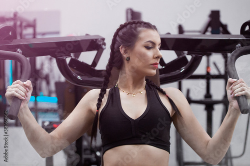 Beautiful woman doing exercises at the gym with fitness clothes.
