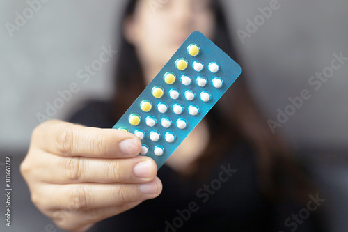 Women carry birth control pills, focus Hand