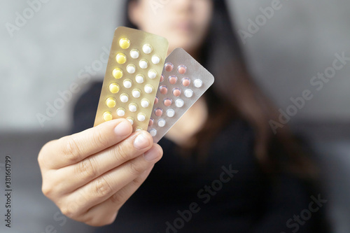 Women carry birth control pills, focus Hand
