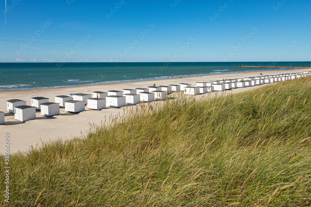 The beach of Løkken, Denmark, with it's white wooden beach huts The beach of Løkken, Denmark, with it's white wooden beach huts
