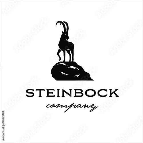 The Alpine ibex stands on the edge of a cliff in a classic style design