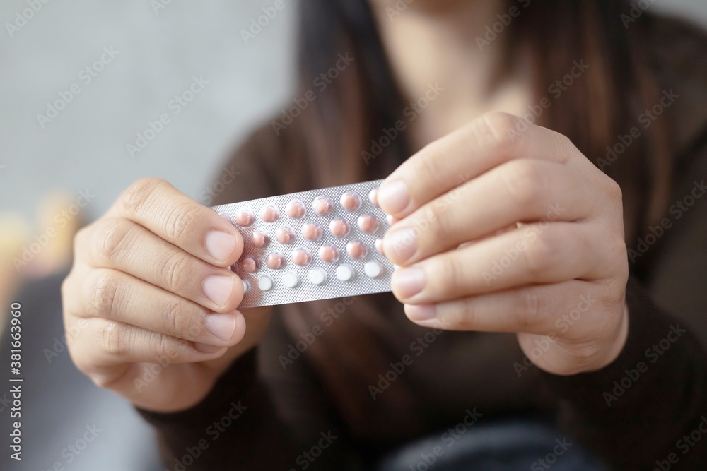 Women holding birth control pills Women holding birth control pills