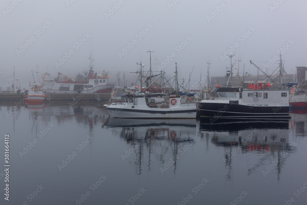 Fog in port of the polar town Vardo of the coast of the Barents sea, Varanger national scenic route in Finnmark, Norway