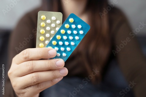 Women holding birth control pills