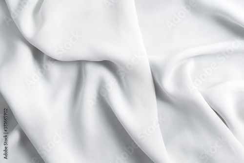 Crumpled textile fabric background of light grey color.