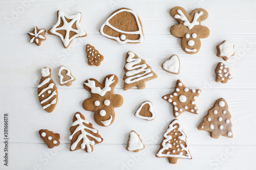 Christmas gingerbread cookies on white wooden background, flat lay