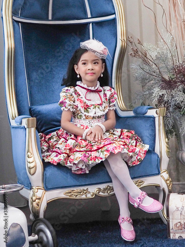 beautiful girl wearing a floral dress in retro style.