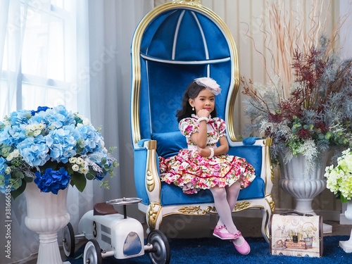 beautiful girl wearing a floral dress in retro style.