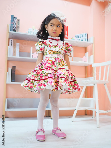beautiful girl wearing a floral dress in retro style.