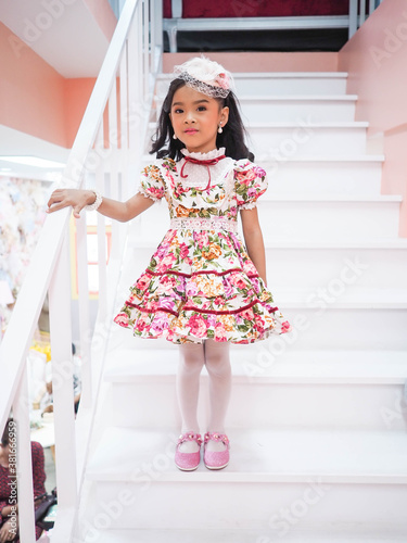 beautiful girl wearing a floral dress in retro style.