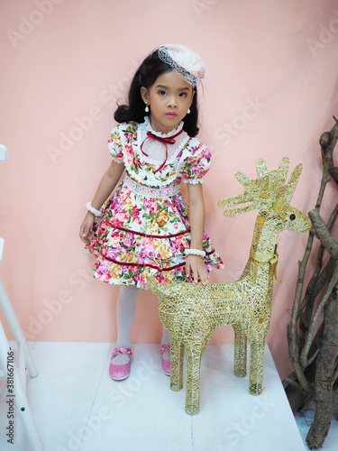 beautiful girl wearing a floral dress in retro style.