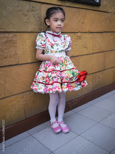 beautiful girl wearing a floral dress in retro style.