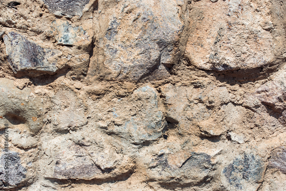 Old background. Grunge dirty old brick stone wall exterior. Ancient temple architecture.