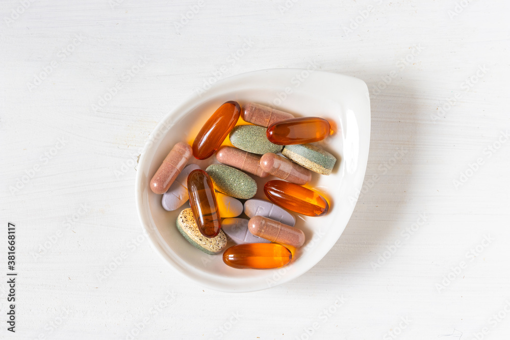 Φωτογραφία Variety of vitamin pills on white wooden background, supplemental and healthcare