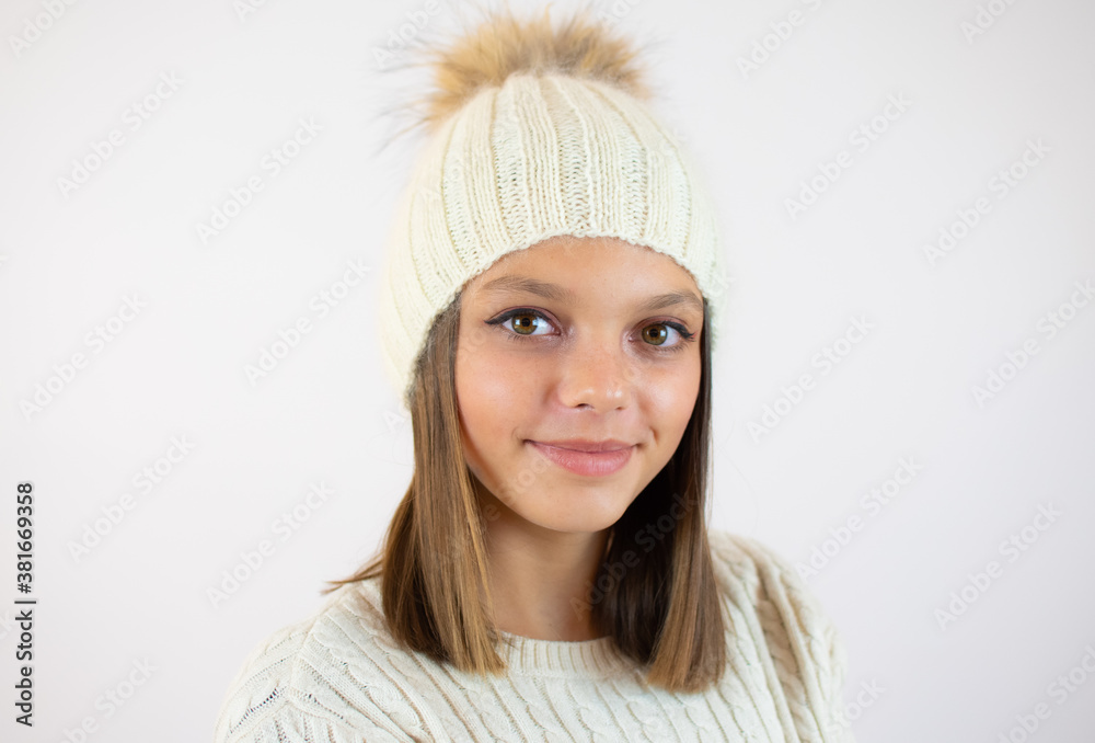 Close up portrait of a pretty girl in winter clothes over white background Close up portrait of a pretty girl in winter clothes over white background