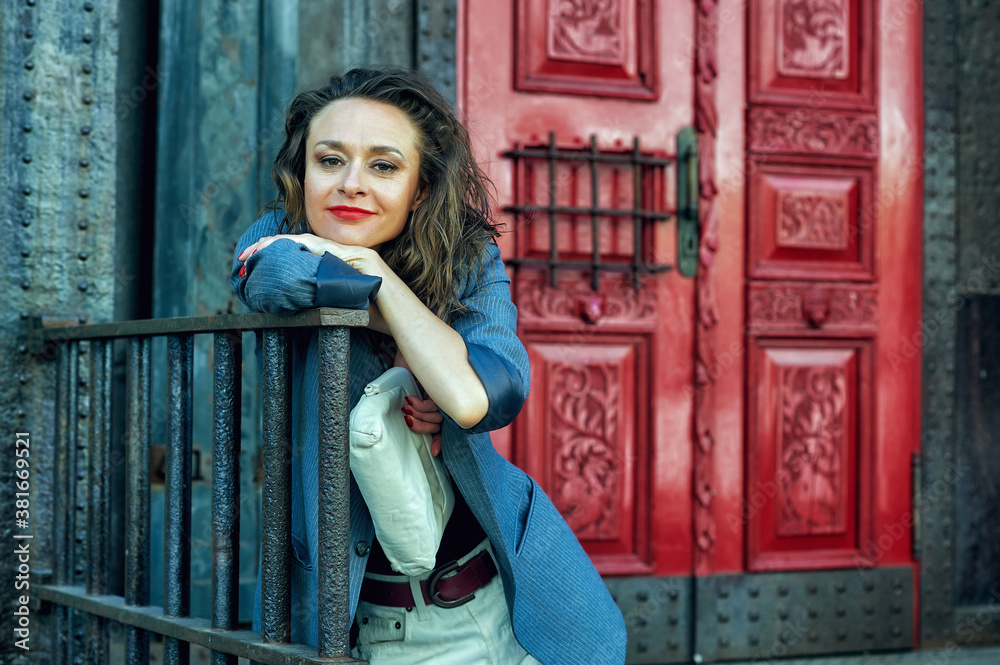 Fototapeta premium Portrait of a young stylish woman in the city