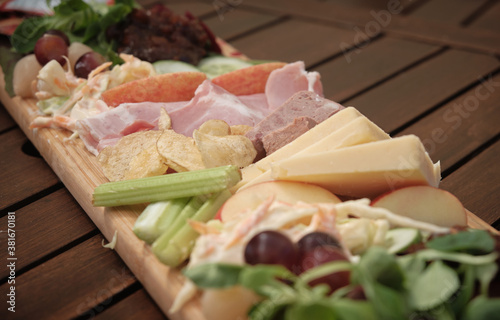 Ploughman's lunch served in on a wooden plank