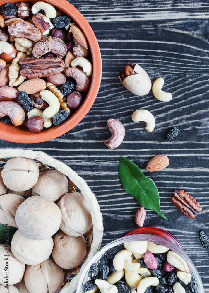 variety of nuts almonds hazelnuts cashews walnuts on a dark wooden background vertical
