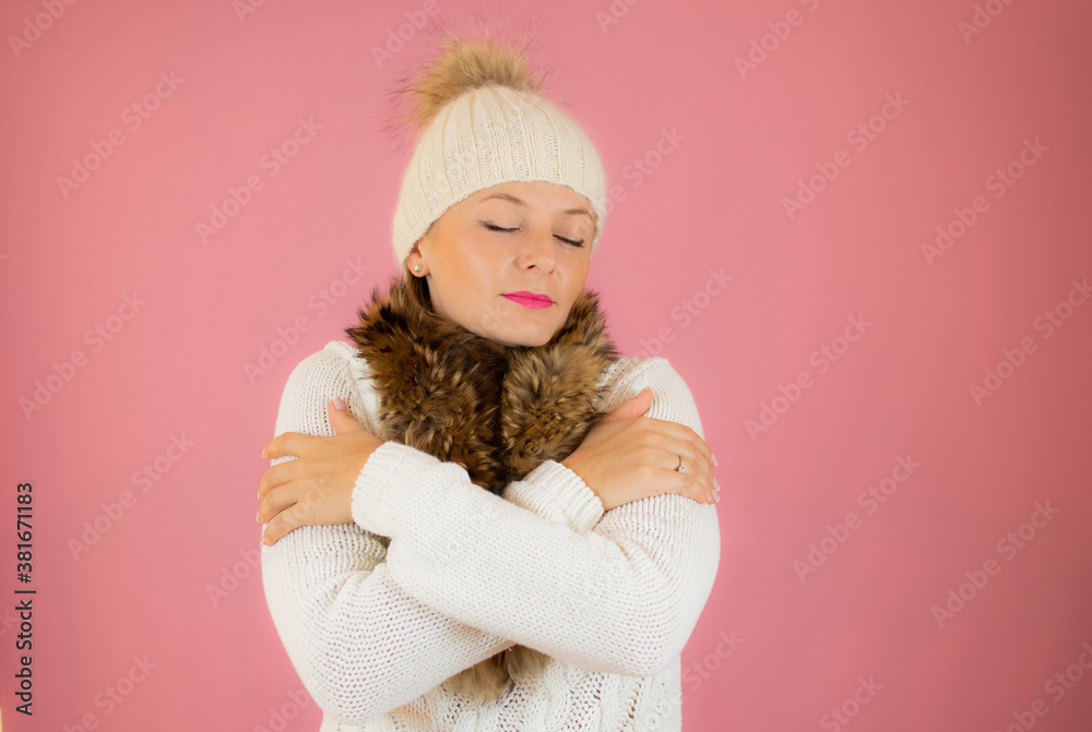 Portrait of a happy young woman dressed in winter clothes standing isolated over pink background Portrait of a happy young woman dressed in winter clothes standing isolated over pink background