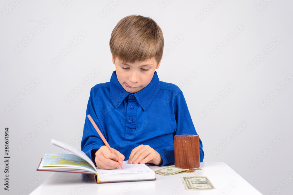 young businessman: a Young boy enthusiastically writes in a Note young businessman: a Young boy enthusiastically writes in a Note