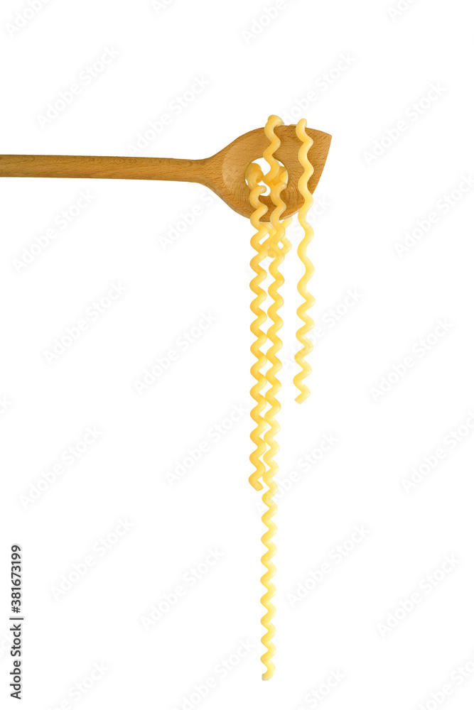 italian fusilli spaghetti pasta hanging on a wooden spoon, isolated on white