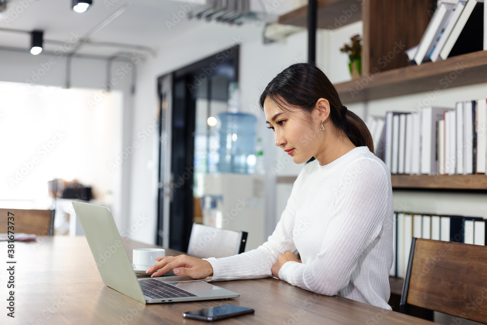 Asian young Businesswoman working laptop computer on wood desk in Home Asian young Businesswoman working laptop computer on wood desk in Home