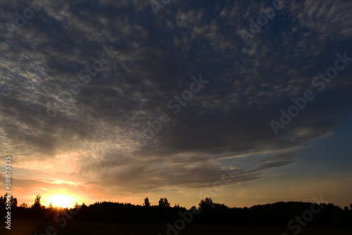 Blue Sky in Moving Cirrus Clouds in Sunrise Sunlight