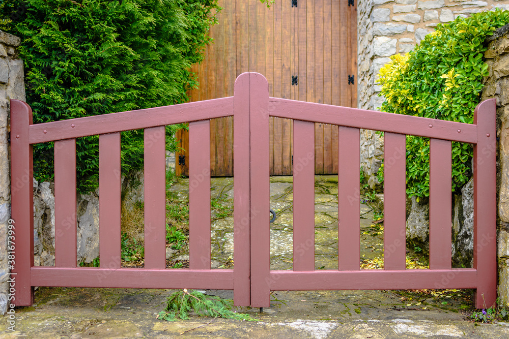 Wooden fence with brown door in the background. Wooden fence with brown door in the background.