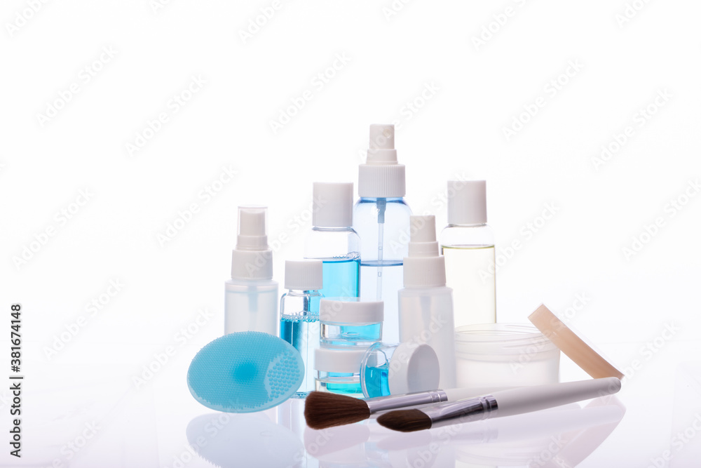 Organic cosmetic daily skincare products, different bottles jars with liquids, makeup tools isolated on white background. Skin care routine, dermatology, beauty, treatment, personal hygiene concept Organic cosmetic daily skincare products, different bottles jars with liquids, makeup tools isolated on white background. Skin care routine, dermatology, beauty, treatment, personal hygiene concept