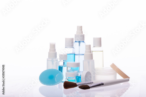 Organic cosmetic daily skincare products, different bottles jars with liquids, makeup tools isolated on white background. Skin care routine, dermatology, beauty, treatment, personal hygiene concept