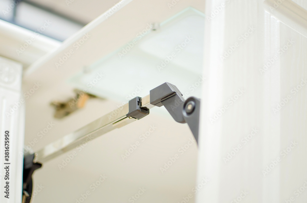 Lifting mechanism of the kitchen facade. Close-up. Lifting mechanism of the kitchen facade. Close-up.