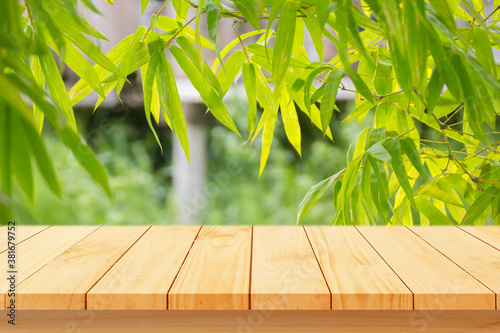 Wood floor with blurred trees of nature park background and summer season  product display montage