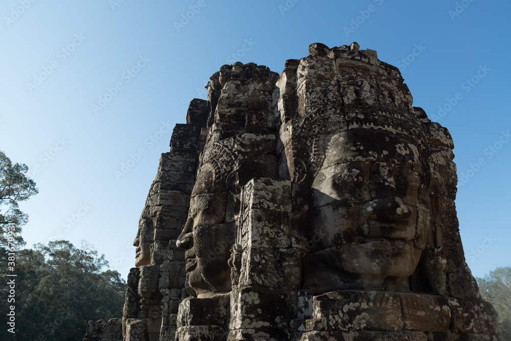 The Bayon is a richly decorated Khmer temple with the multitude of serene and smiling stone face stands at the center of Angkor Thom, Siem Reap, Cambodia.