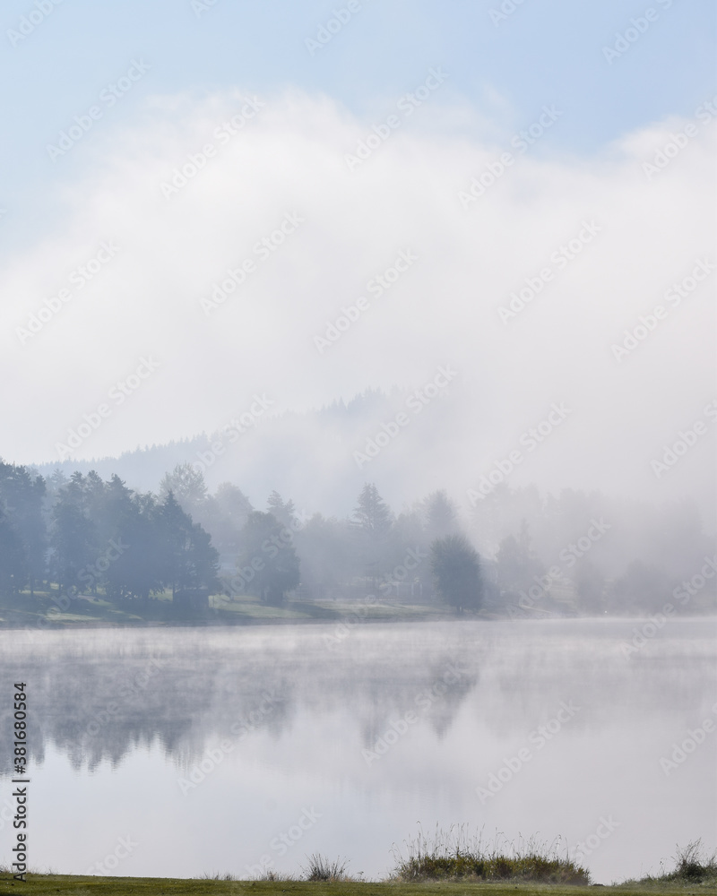 Fog over a lake in the morning in Lipno Nad Vltavou, Czech Republic Fog over a lake in the morning in Lipno Nad Vltavou, Czech Republic