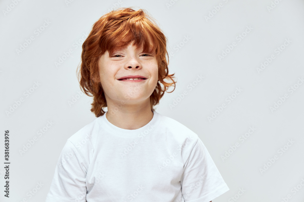 Smiling redhead boy looking forward cropped view of white t-shirt Smiling redhead boy looking forward cropped view of white t-shirt