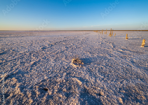 Sunset on the Genichesk pink extremely salty lake  colored by microalgae with crystalline salt depositions   Ukraine.