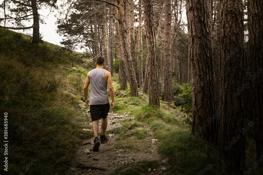 Young caucasian man exploring a foggy forest in Artikutza, Basque Country. Young caucasian man exploring a foggy forest in Artikutza, Basque Country.