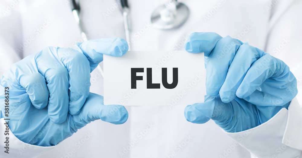 a doctor showing a card with the word flu written in it a doctor showing a card with the word flu written in it