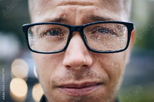 Man with eyeglasses in rain photo