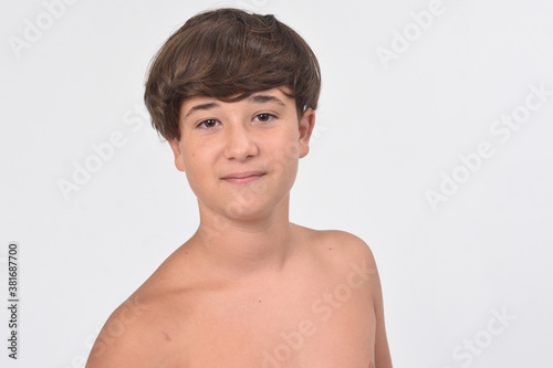 Εκτύπωση καμβά portrait of a shirtless teen boy on white background, front view