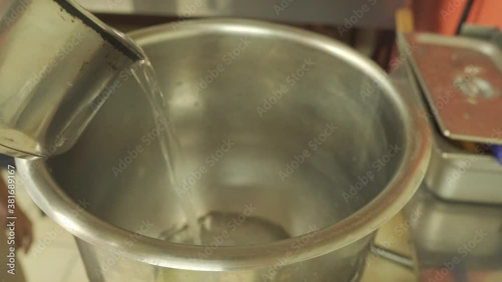 Water Being Poured into Large Mixing Bowl Water Being Poured into Large Mixing Bowl